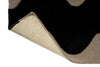 Extreme close up of a Marimekko NZ wool Rug with black wavy pattern on beige showing the backing