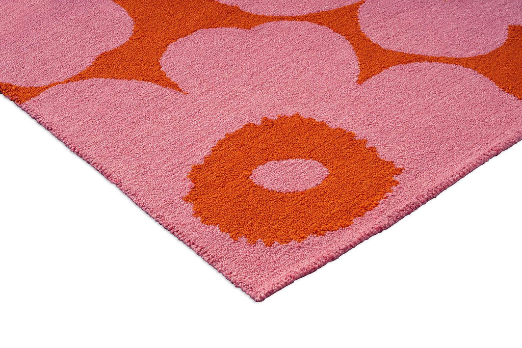 Close-up of a Marimekko Unikko pink and orange floral patterned outdoor rug