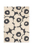 Floral patterned rug with black flowers on a beige background