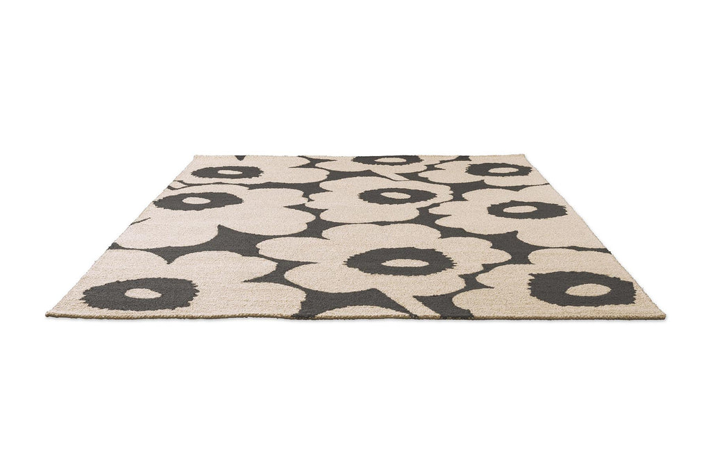 Marimekko floral patterned outdoor rug with black flowers on a beige background