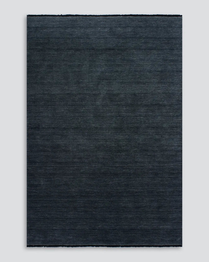 The Baya Sandringham 100% wool floor rug in colour 'Storm Blue' seen in full