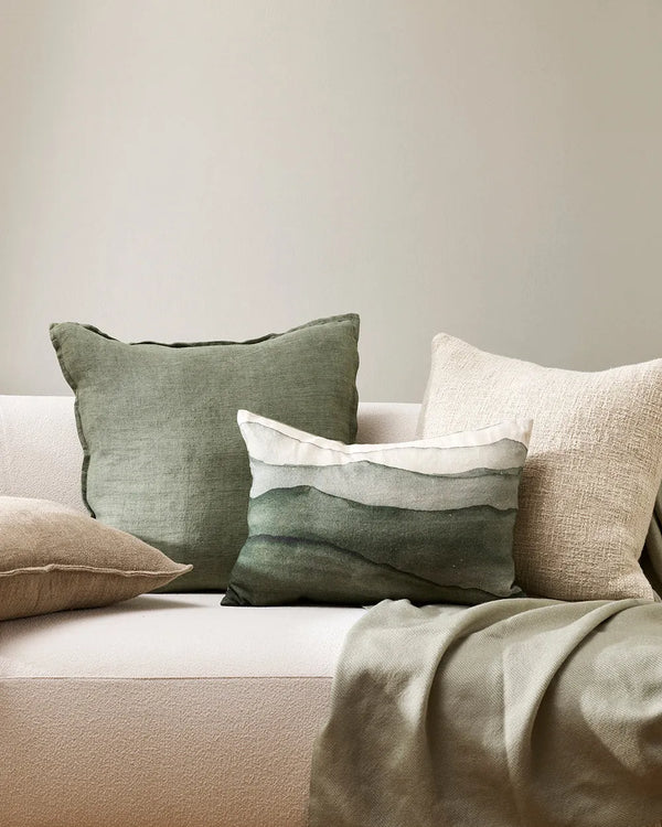 Baya Cassia linen cushion in colour Moss, next to the Baya Aurelia cushion