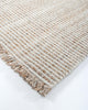 A close up of the Rhodes Teak outdoor runner rug, highlighting the cream and brown weave and fringe detail