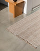 The Rhodes Teak brown runner rug on the floor of a modern kitchen