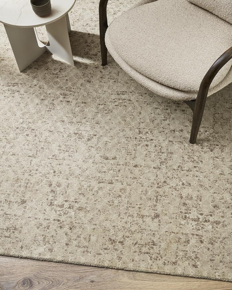 The Baya 'Cadence' pure wool floor rug seen in a modern living room under a chair and coffee table.