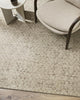 The Baya 'Cadence' pure wool floor rug seen in a modern living room under a chair and coffee table.