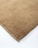 The Baya Sandringham light-mid brown 'Fenugreek' wool rug, seen close up at the corner highlighting the fringe detail