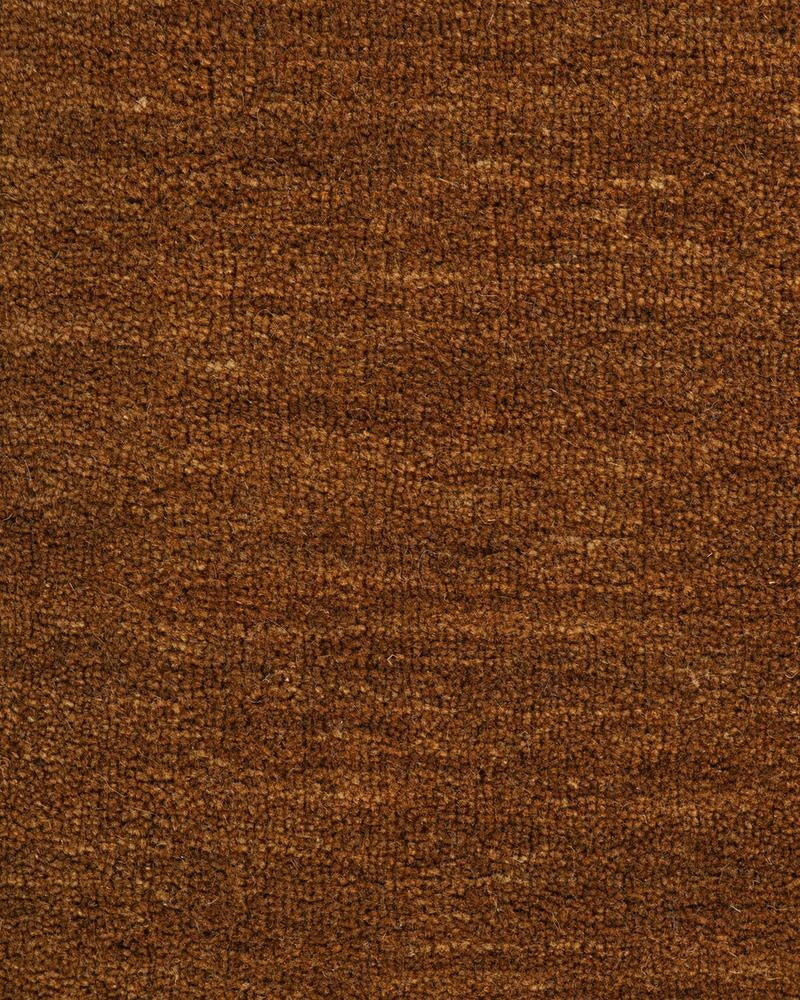 The rich brown 'pecan' brown colour of the Sandringham wool runner rug, shown here as a close up of the wool cut pile.