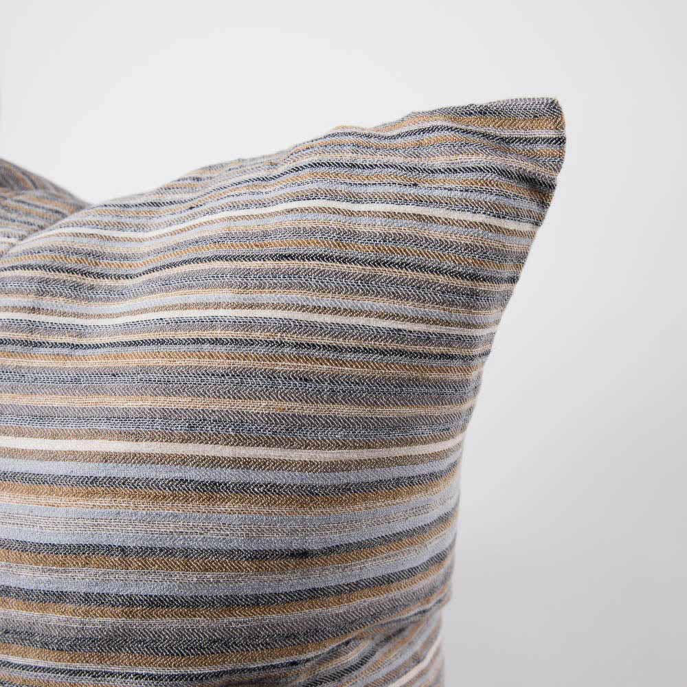 A corner view of the Coast cushion in Multi colour stripes by Eadie. 