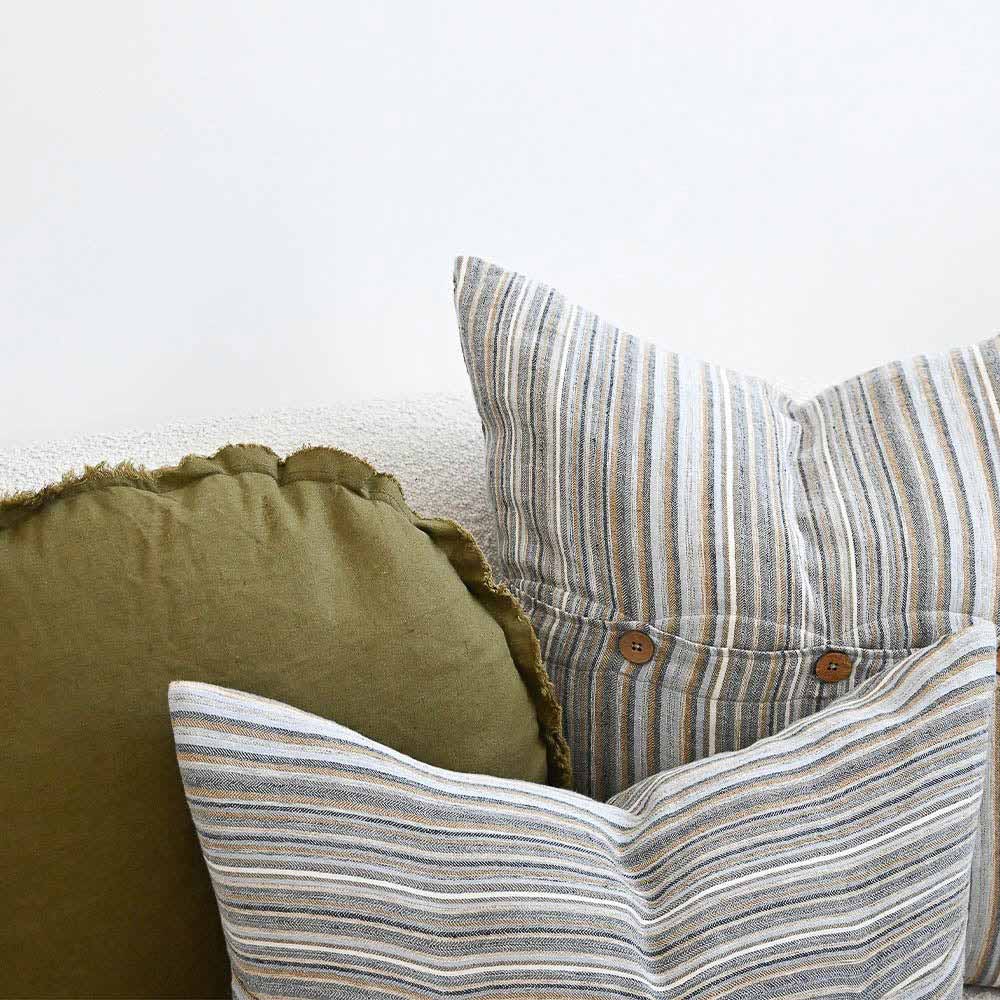 Two of the Coast cushions by Eadie. The stripes of the cushions compliment the green cushion they are next to 