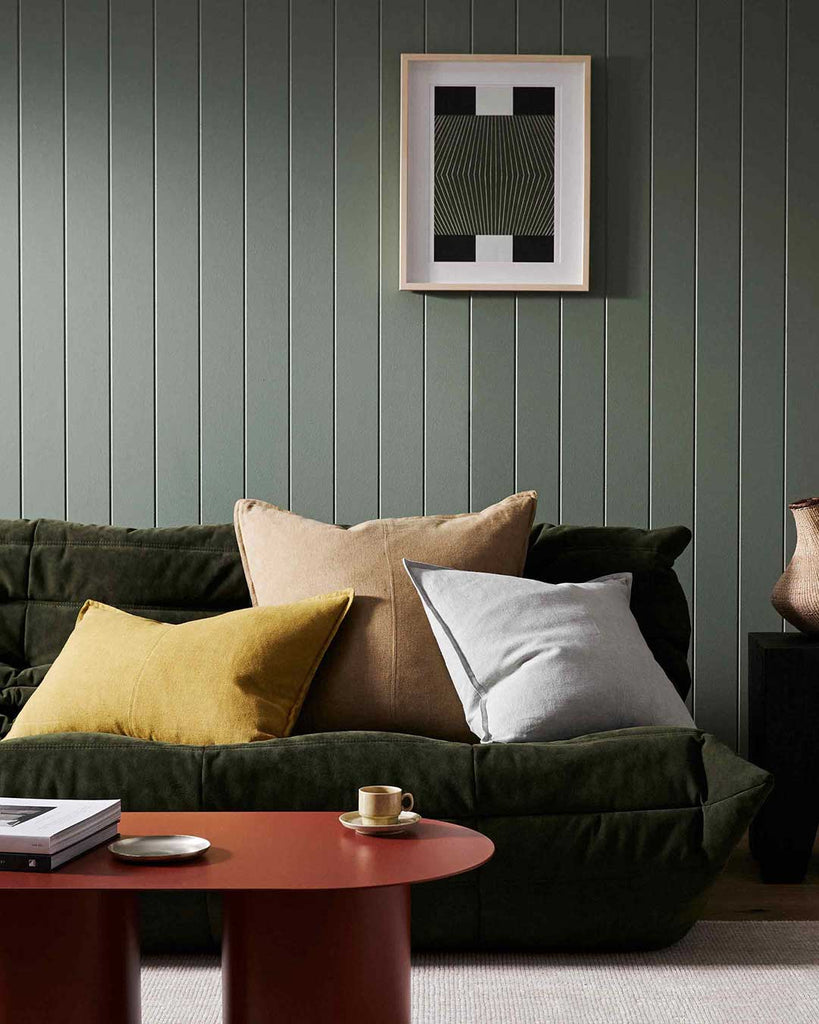 Weave cushions on a couch in a green room interior