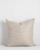 A beautiful beige designer cushion by Baya NZ, seen against a white background.