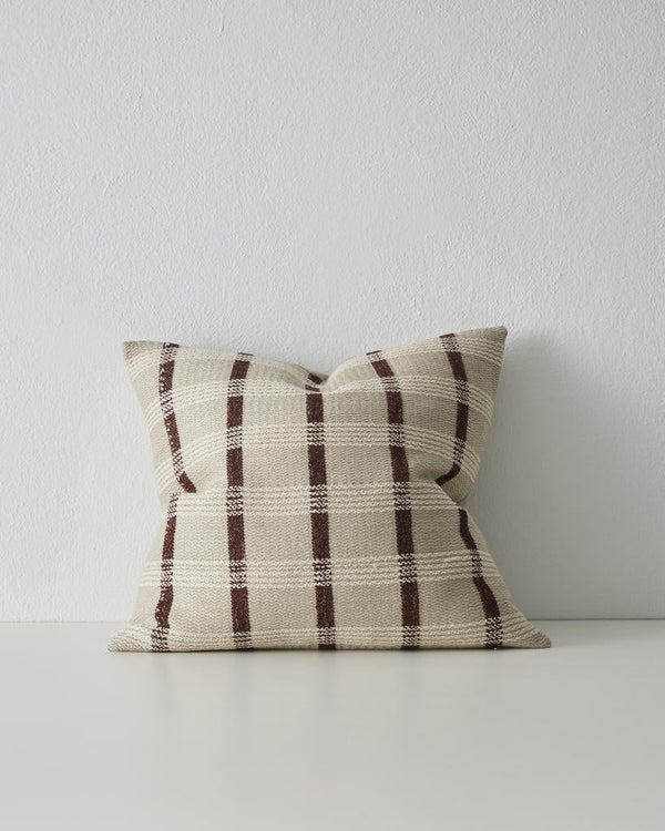 The Weave Home 'Marmaris' cushion featuring a dark brown stripe set against a contrasting white and neutrals.