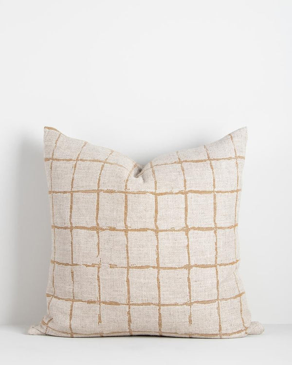 A natural linen-blend cushion with an ochre grid-look design in a hand-painted style. 