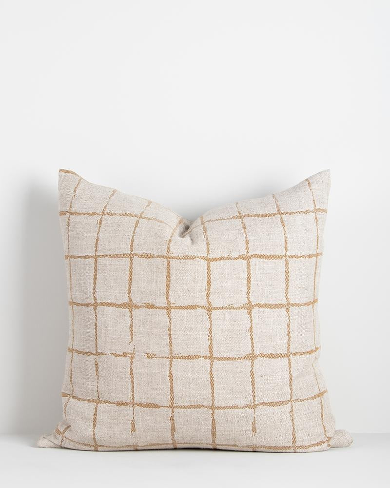 A natural linen-blend cushion with an ochre grid-look design in a hand-painted style. 