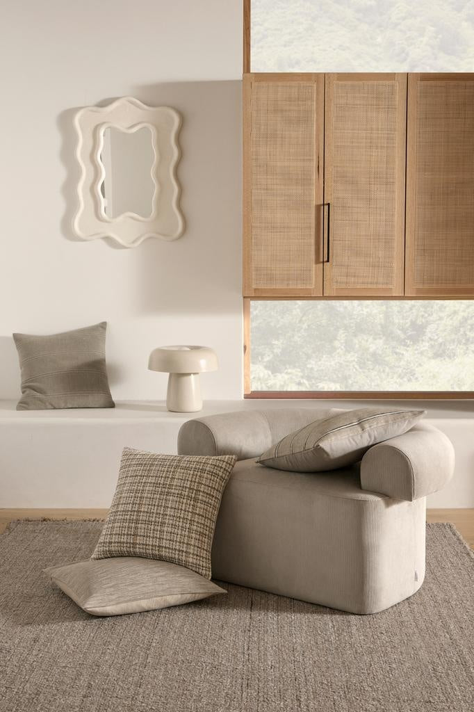 Floor rug and cushions in warm neutral colours, by Weave Home nz, in a light, modern home