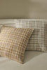 Textural woven cushions in earthy colours, by Weave Home nz, sitting together on a cream couch