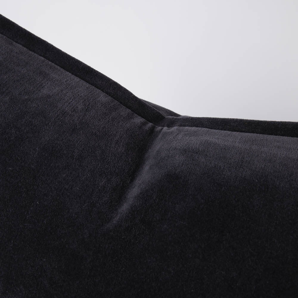 A detail image of a velvet long lumbar cushion, in a deep midnight blue shade by Eadie Lifestyle