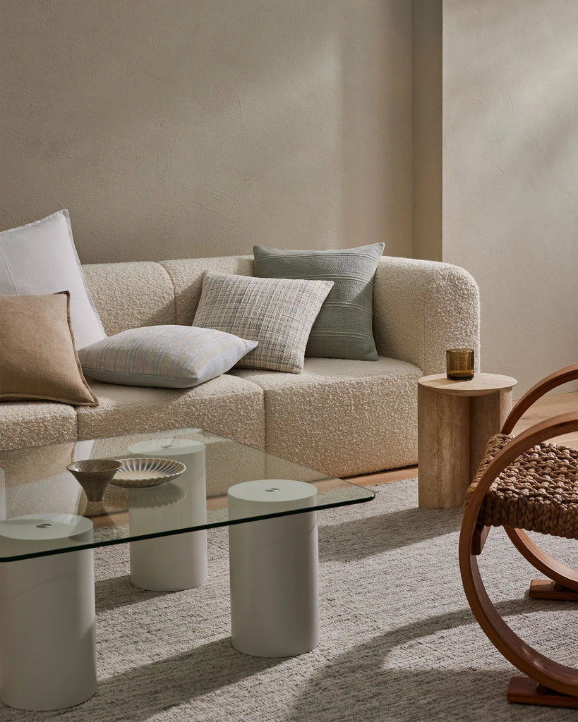 Designer cushions by Weave Home NZ on a couch in a modern living room whcih also features the Weave Puglia cushion.