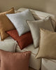 Beautiful Fiore cushions, by Weave Home, in trending colours seen in a pile on a couch