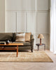 A sophisticated living room in warm cream tones with a soft floor rug in light sandy brown tones, made with bamboo silk and natural jute fibres by Baya 