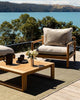 A stunning outdoor seating area featuring the olive green handwoven Lonsdale outdoor rug by Baya