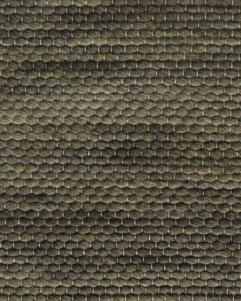 Close up shot of the kahki green wool floor rug textural weave