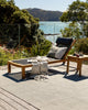 The large, green Lonsdale outdoor rug by Baya, seen on a stylish outdoor deck with modern outdoor furniture