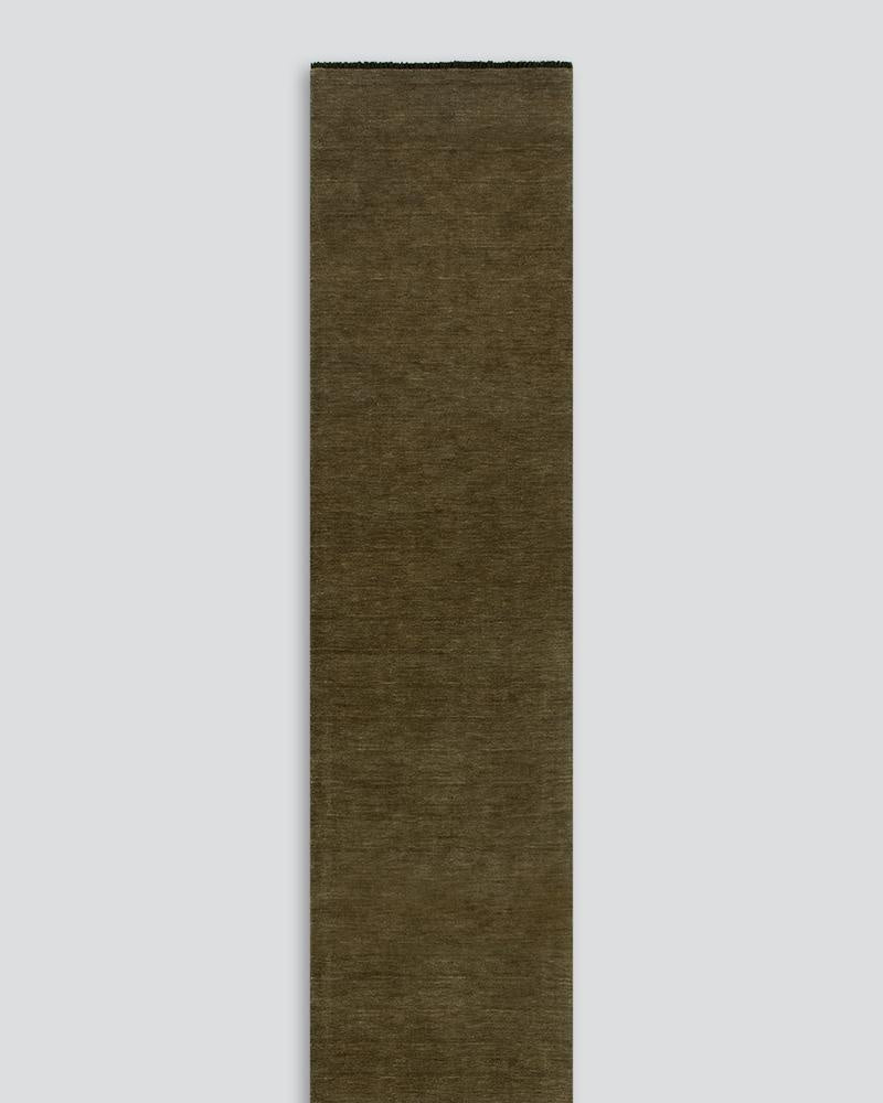 The olive green 'Moss' Sandringham wool runner rug by Baya, seen in full from above.