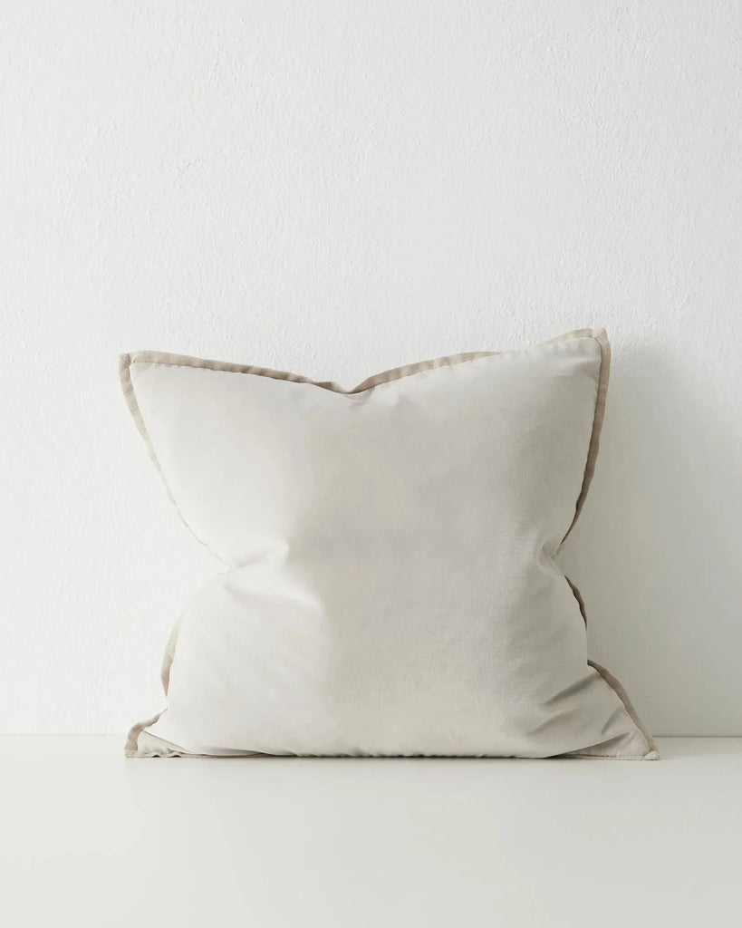 A cool, grey-white coloured velvet cushion with a linen flange detail, by Weave Home nz