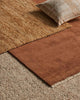 A number of floor rugs from Weave Home in complimentary shades of brown with different textures. 
