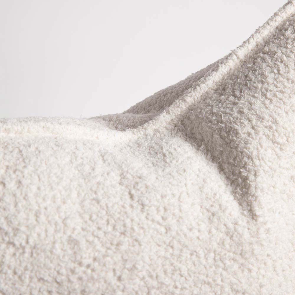 A detail image of the hem of a creamy white cushion by Eadie Lifestyle 