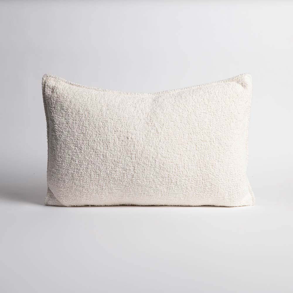 A full image of a delicately textured white lumbar cushion by Eadie Lifestyle. 