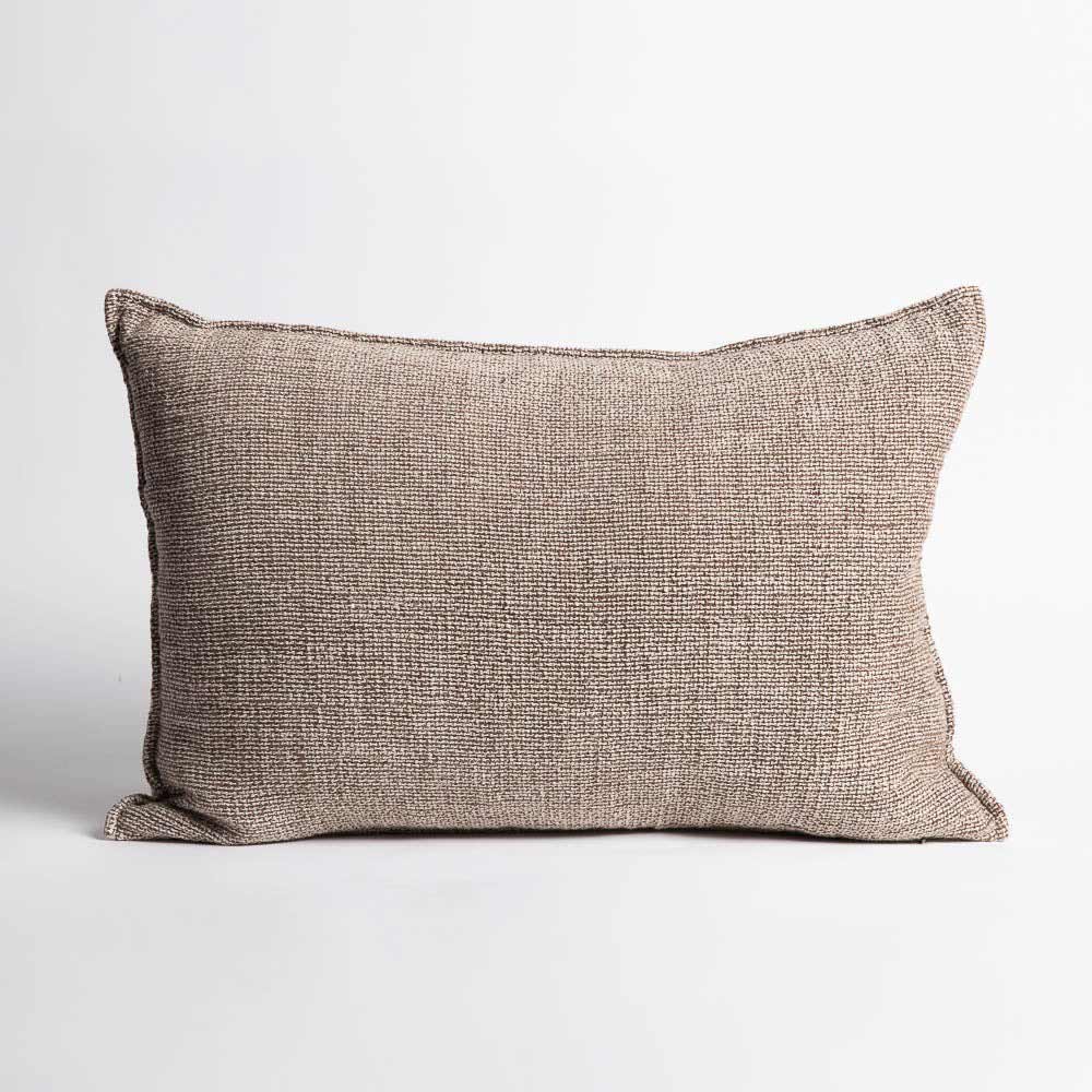 A lumbar cushion in neutral taupe, with a small detailed hem and a natural style weave