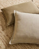 Two neutral linen cushions sitting on the wool boucle Henley floor rug by Weave nz