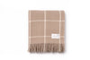 A nz wool throw blanket in a neutral light brown, woven in a tan modern check, by Ruanui Station