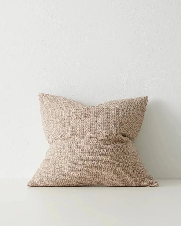 A neutral, textural cushion by Weave Home in a natural linen colour