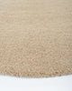 Close up edge of a light brown boucle weave wool floor rug - the Dorset Biscuit by Baya