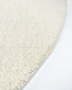 The beautiful Dorset Natural White boucle-style floor rug by Baya, seen close up in perspective on the curved edge