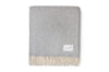 A soft, neutral grey wool throw, by Ruanui Station, in a pretty chevron pattern, 100% nz made