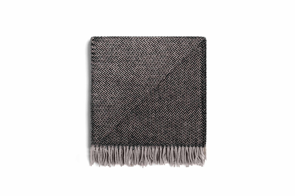 The Ruanui STation charcoal chevron throw blanket with tasselled fringe