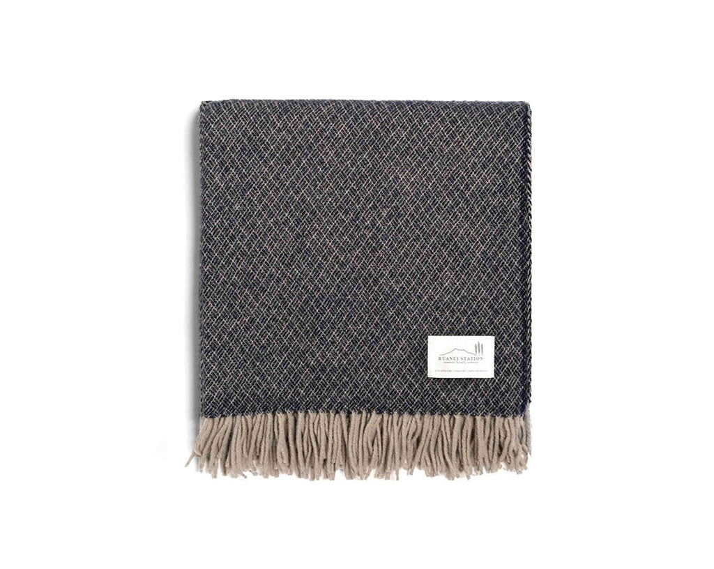 A dark blue NZ wool throw featuring a diamond weave pattern,made by Ruanui Station in NZ