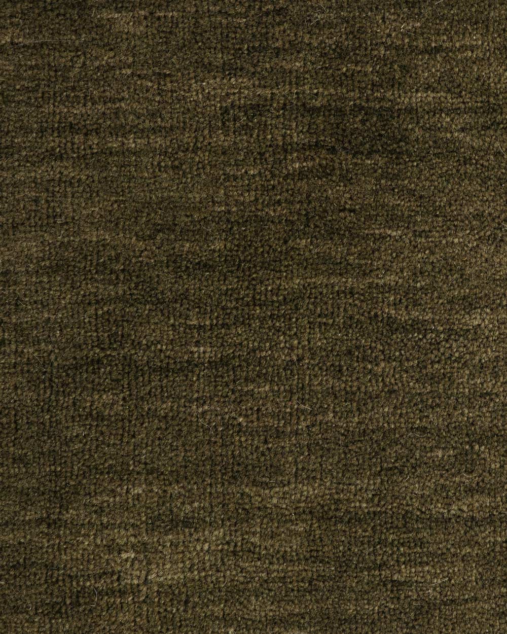A close up image of the weave of a moss green floor rug in 100% wool. 