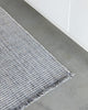 Close up of the slate grey Rhodes runner rug by Baya, seen on a kitchen floor