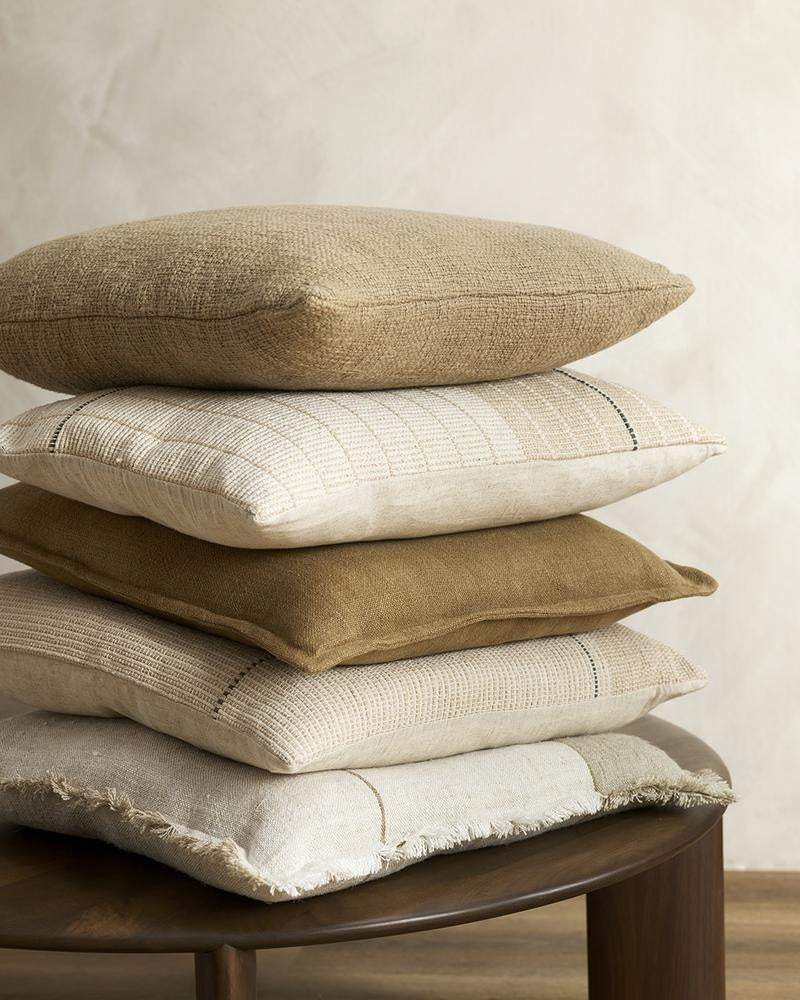 Stack of crea, brwon and white cushions in linen and cotton, by Baya NZ.