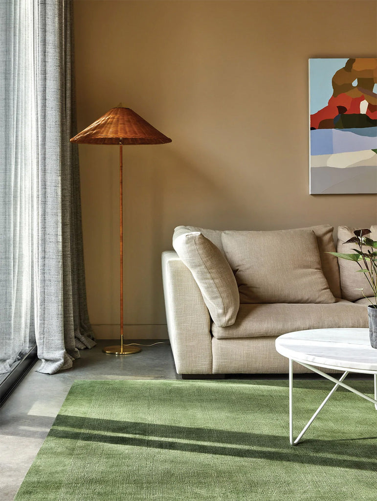 A stylish living room featuring the Tribe Home NZ Tait wool rug in colour Watercress