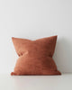 A textural cushion in a warm rust orange red tone. 