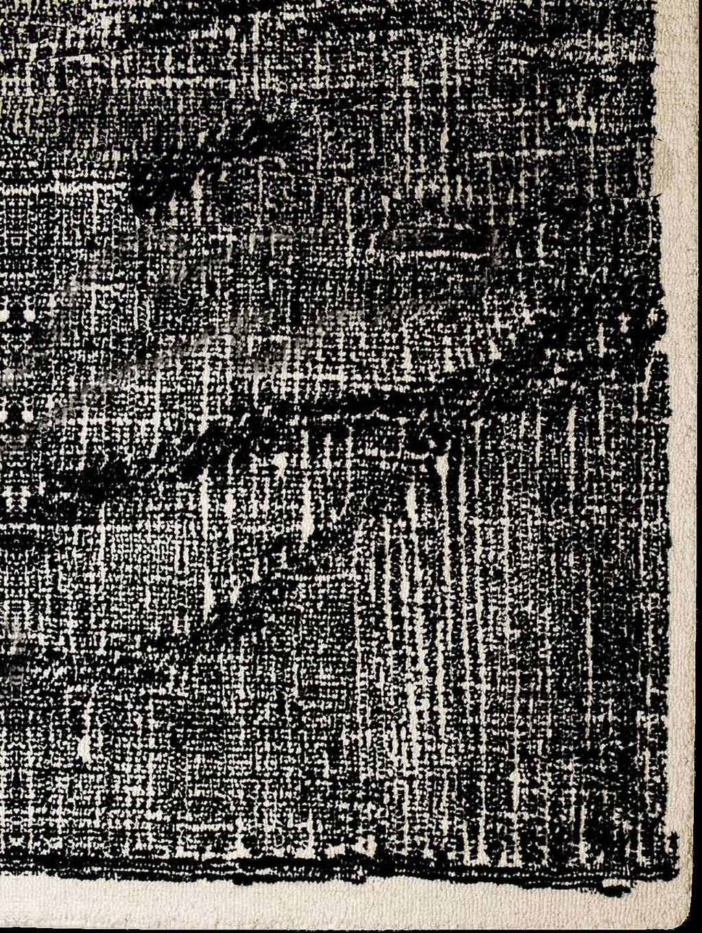 A corner of the black and white Elio 100% wool rug by Tribe Home, shown from abive