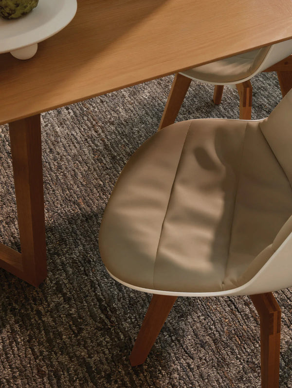 Close up view from above of the Tribe Home NZ Peru wool and jute rug under a table and chair