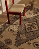 Close view of the Tribe Home Ellora wool and jute rug's diamond motif beside a red chair